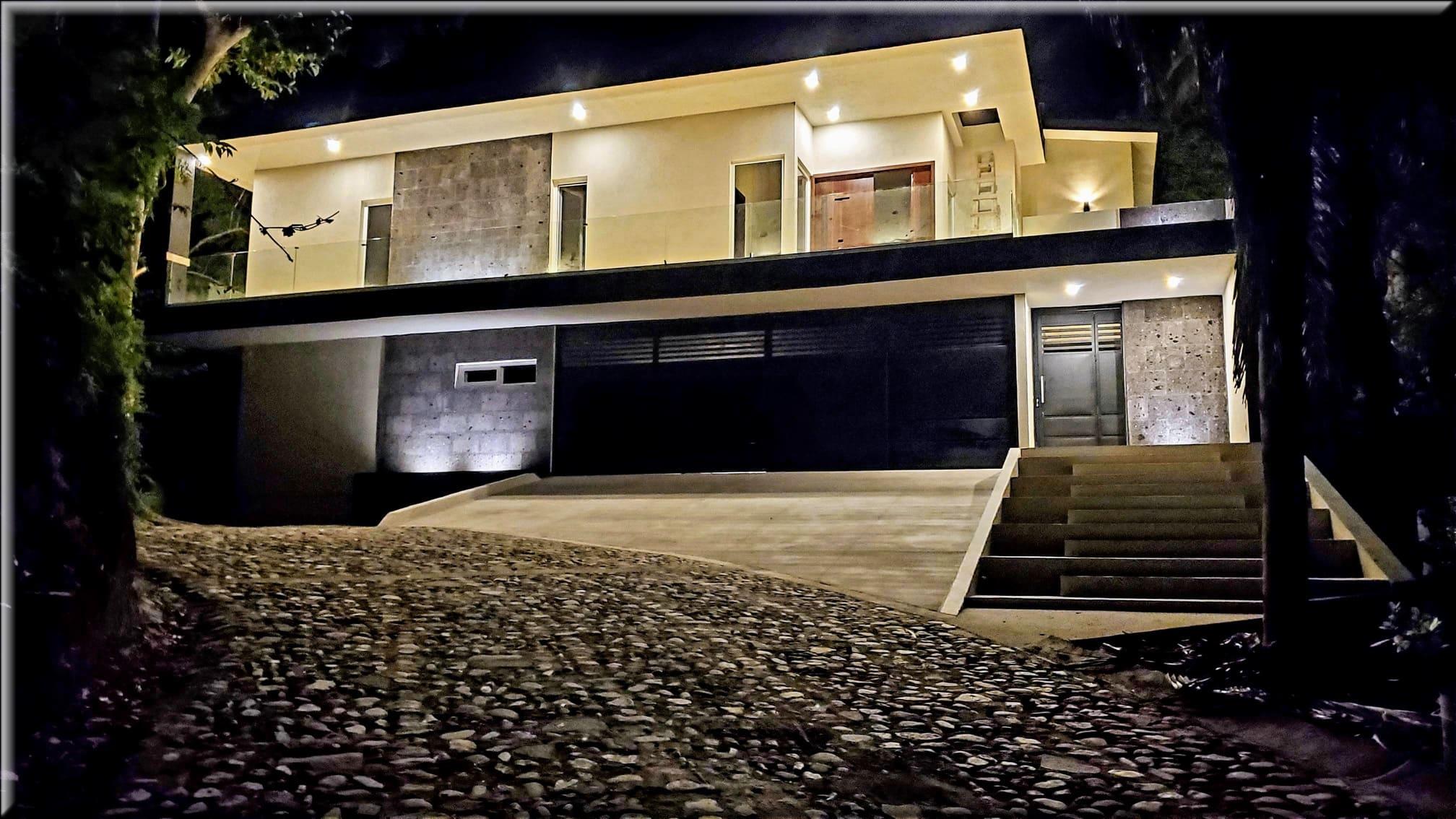 Front view of illuminated Selva Suites rental at night