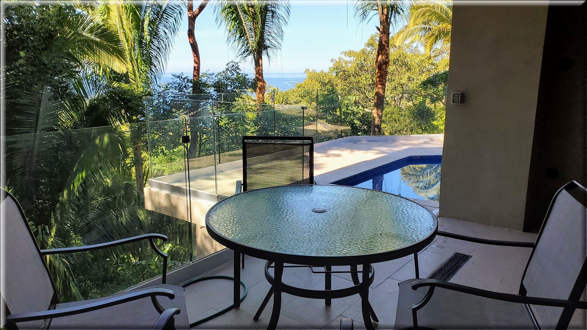 Private veranda with jungle and partial ocean views.
